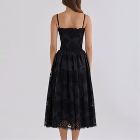 Model wearing House of CB black lace midi dress with spaghetti straps, fitted bodice and full skirt, shown from the back