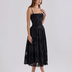 Model wearing House of CB black lace midi dress with spaghetti straps, fitted bodice and full pleated skirt with scalloped hem