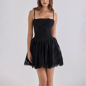 Model wearing House of CB black lace corset mini dress with spaghetti straps and full skirt silhouette