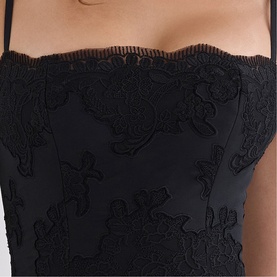 Model wearing House of CB black strapless corset dress with floral lace appliqu&eacute; detail and scalloped neckline.