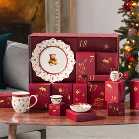 Villeroy & Boch advent calendar set in red and white with gold Winnie-the-Pooh motifs, including plates, mugs, and bowls