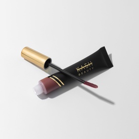 Kash Beauty Blush in muted mauve-rose, squeeze tube with gold-capped doe-foot applicator wand, shown open and crossed