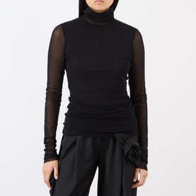 Model wearing MeiMeij nero turtleneck mesh long-sleeve top, styled with black satin wide-leg trousers with floral detail.