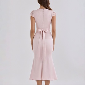 Model wearing House of CB Crystal Pink midi dress, back view, lace cap sleeves, satin bow tie waist, fishtail hem