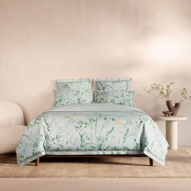Sheridan Light Blue Duvet Set with floral botanical print, styled on a bed with matching pillowcases in a neutral bedroom setting.