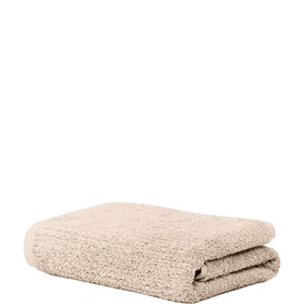 Sheridan Plain Towel in Stone, neatly folded, showing textured cotton weave in a warm neutral tone.