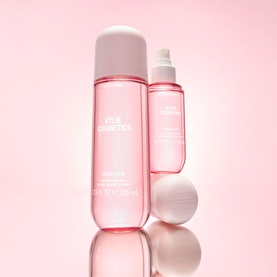 Kylie Fragrance Vanilla Dew Hair & Body Mist in pink bottles, large spray and travel-size mist with matching cap on pink background.