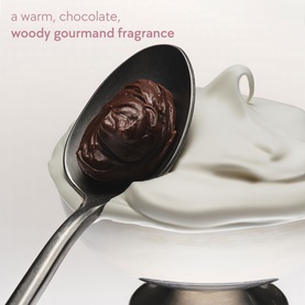 Kylie Fragrance Sweet &Eacute;clair Hair & Body Mist lifestyle shot with chocolate on a spoon over cream, evoking warm woody gourmand scent