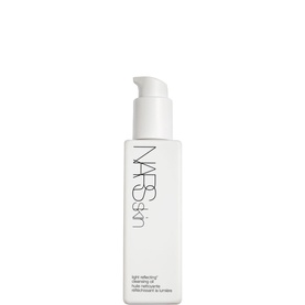 NARS Light Reflecting Cleansing Oil in a white pump-top bottle with minimalist branding on a white background