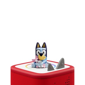 Tonies Bluey character figure in multi-coloured design, placed on red Toniebox speaker