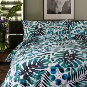 White duvet set with tropical green and teal palm leaf print, styled on a double bed with matching pillowcases
