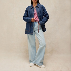 Model wearing White Stuff mid denim oversized shirt jacket, styled with light wash wide-leg jeans and a pink top