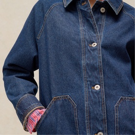 Model wearing White Stuff mid denim jacket with contrast plaid cuff lining, front patch pockets and button fastening, close-up detail view