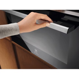 Electrolux 800 MealAssist CombiQuick Microwave and Built-in Oven in black, hand pulling open silver handle drawer close-up