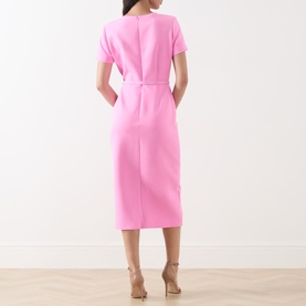 Model wearing FeeG Felicity Belted Pencil Dress in pink, back view, midi length with short sleeves and fabric belt, styled with nude heeled sandals.