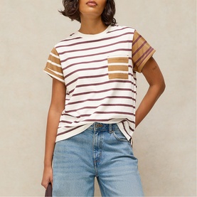 Model wearing White Stuff ivory multi stripe cotton T-shirt with chest pocket, styled with blue denim jeans.