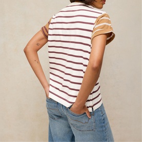 Model wearing White Stuff ivory multi stripe short sleeve T-shirt, back view, styled with blue jeans.