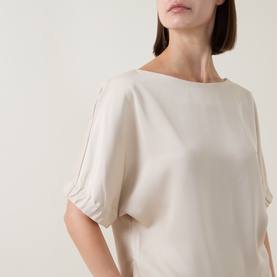 Model wearing FeeG Champagne Top with bateau neckline, elasticated short sleeves, and relaxed silhouette in lightweight fabric.