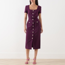 Model wearing FeeG plum midi dress with square neckline, short sleeves, gold button-front detail and front split, styled with pink heeled sandals.