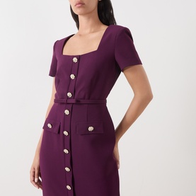 Model wearing FeeG plum dress with square neckline, short sleeves, floral gold-tone buttons and front pockets