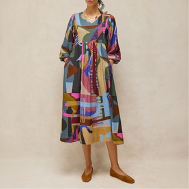 Model wearing White Stuff midi dress in pink multicolour abstract print, long sleeves, gathered waist, with tan flat shoes