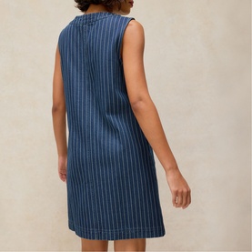 Model wearing White Stuff denim multi sleeveless shift dress with white pinstripe, shown from the back, above-the-knee length.