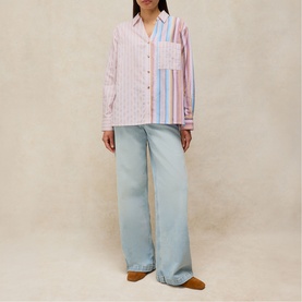 Model wearing White Stuff pink multi stripe shirt with chest pocket, styled with light blue wide-leg jeans and tan mules.