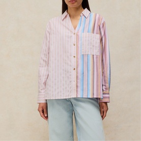 Model wearing White Stuff pink multicolour striped cotton shirt with chest pocket, styled with light blue wide-leg jeans
