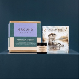 Ground Wellbeing Storytime Massage gift set with balm jar, illustrated gift box, and otter-themed storybook on teal background