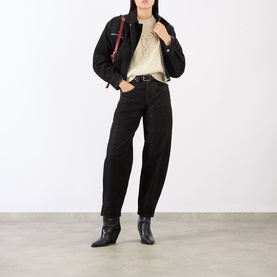 Model wearing Isabel Marant Etoile black jeans with cream top, black cropped jacket, ankle boots and red crossbody bag.