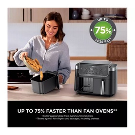 Model using a large dual-basket black air fryer, adding food to basket, with "Up to 75% Less Fat" and "75% Faster Than Fan Ovens" text overlay