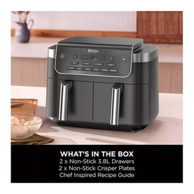 Ninja dual-zone air fryer in dark grey with two drawers, shown above a what's in the box contents panel listing included accessories.