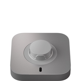 Space grey compact square device with central rotary dial knob and small indicator port on front face