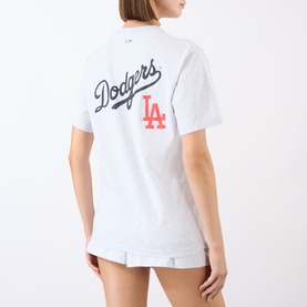 Model wearing Sporty and Rich Dodgers tee in Heather Gray, back view showing navy script and Fire Red LA graphic, paired with white shorts