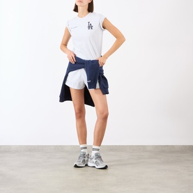 Model wearing Sporty and Rich Heather Gray Navy/Fire Red cotton top, styled with navy shorts and white trainers.