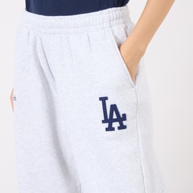 Model wearing Sporty & Rich Heather Gray Navy LA Dodgers sweat shorts, elastic waist, hands in pockets, navy logo embroidery detail.