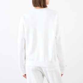 Model wearing Sporty and Rich White Team Blue cotton sweat top, shown from the back, styled with matching white joggers.
