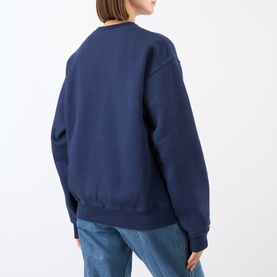 Model wearing Sporty and Rich Dark Navy White cotton sweat top, back view, styled with light blue denim jeans.