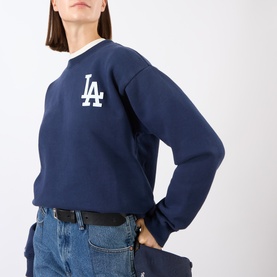 Model wearing Sporty and Rich Dark Navy White LA Dodgers cotton sweat top, styled with blue jeans and black belt.