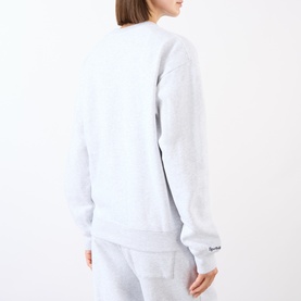 Model wearing Sporty and Rich Heather Gray Navy sweatshirt, back view, styled with matching gray sweatpants