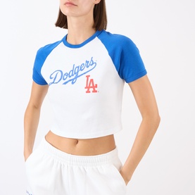 Model wearing Sporty and Rich white and team blue Dodgers LA cropped cotton T-shirt, styled with white shorts