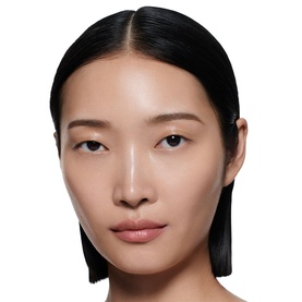 Model wearing Victoria Beckham Lip Definer lip liner in a nude-pink shade, with glowing, natural-finish skin