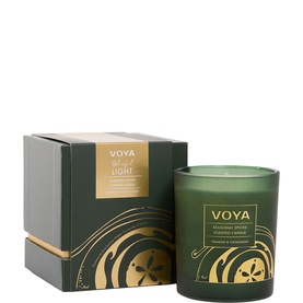 Voya First Light Seasonal Spiced Scented Candle in dark green glass vessel with gold botanical detailing, shown with matching gift box