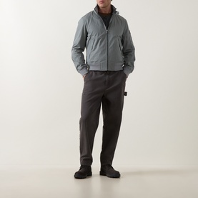 Model wearing Belstaff Atlantic Grey casual jacket with ribbed collar, styled with dark tapered trousers and black boots