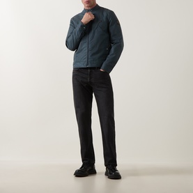 Model wearing Belstaff petrol casual jacket with black jeans and black trainers, full-length front view