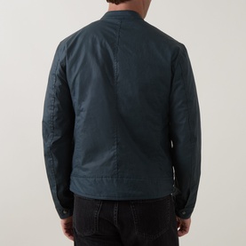 Model wearing Belstaff casual jacket in petrol blue, rear view, shown with dark jeans. Cotton shell with mandarin collar.