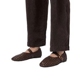 Model wearing All Saints brown woven leather Mary Jane flats with gold buckle strap, styled with dark brown wide-leg trousers