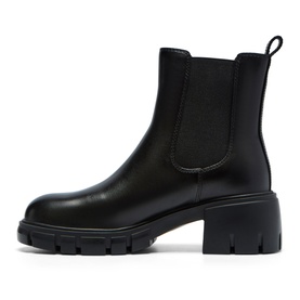 Black leather Chelsea boot with elasticated side panel, block heel, and chunky lug sole, shown in profile