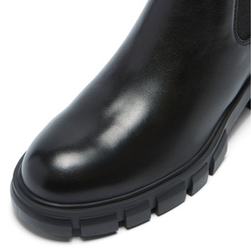 Black leather Chelsea boot close-up showing elasticated side panel and chunky ridged lug sole