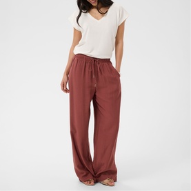 Model wearing Kaffe henna wide-leg drawstring trousers styled with a white short-sleeve V-neck top.